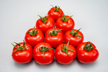 Food triangle, Red ripe tasty Dutch tomatoes, vegetables background top view close up copy space