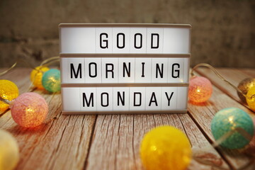 Good Morning Monday text on lightbox on wooden background