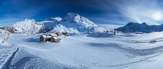 The Simplon Pass, snowy with the peaks of the Lepontine Alps and the small village of 