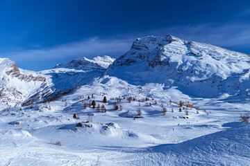 The Simplon Pass, snowy with the peaks of the Lepontine Alps and the small village of 