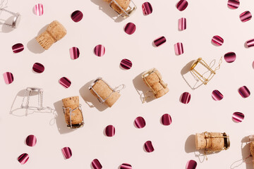 Champagne corks and sparkling confetti, top view composition, holidays, celebration concept. Wooden...