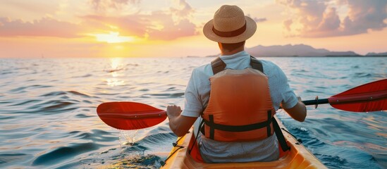 Solo male adventurer kayaking at sunset in pristine blue sea   summer outdoor exploration