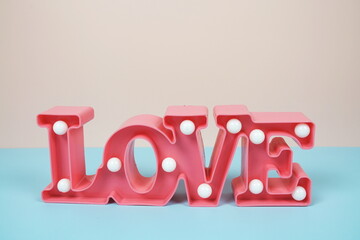 Valentine's Day Background with Love alphabet letter on pink and blue background