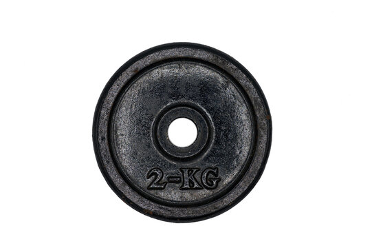 Detail of an old 2kg metal dumbbell disc on a white background