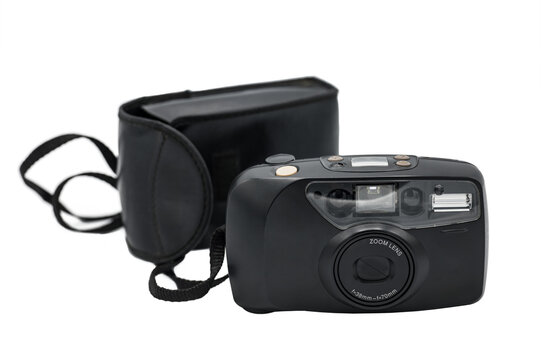 Detail of an old compact camera with its black case on a white background. It is the typical compact zoom camera that has autofocus and automatic reel drag.
