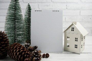 Empty calendar mockup with christmas tree and house lantern decoration on wooden background