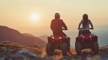 A young man and a woman ride ATVs in the mountains