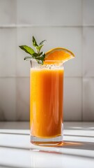A tall glass of freshly squeezed orange juice, garnished with a slice of orange and a sprig of mint. white background