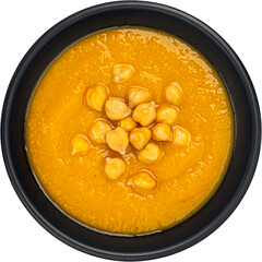 Vegetarian chickpea cream soup isolated, black bowl, top view