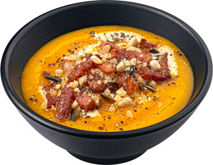 Pumpkin cream soup with crispy bacon isolated on white background