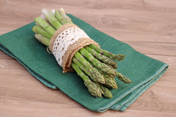 Green asparagus on a kitchen towel.