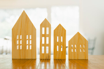 House model on wood table. Real estate agent offer house, property insurance and security,...