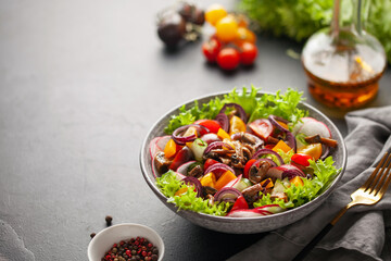 Easy vegetarian salad of fresh cucumber, mushrooms, tomato, sweet pepper, radish and onion in bowl . Healthy food.
