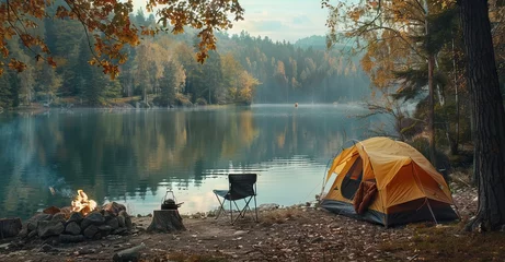 Fotobehang Camping tent, camping chair and fire in the forest near lake on autumn day copy space. AI generated illustration © Or