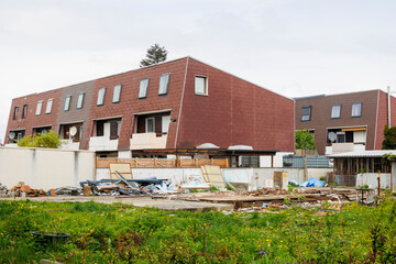A demolished ruin of a building next to box-shaped terraced houses in Königsbrunn near Augsburg in...