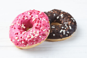Set of colorful donuts on wooden background