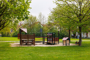 A playground with a bright red play tower and slide in Königsbrunn near Augsburg in Bavaria on a...