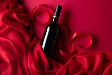 Bottle of red wine on a red background. - 787408101