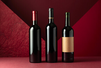 Bottles of red wine on a red background. - 787408148