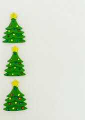Three candy Christmas trees on a white background with copy space