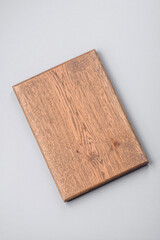 Empty wooden cutting board on gray textured concrete background