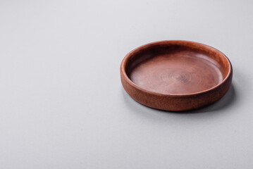 An empty plate on a gray concrete background with copy space