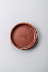 An empty plate on a gray concrete background with copy space