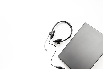 VOIP headset on laptop, top view. IT support, call center and customer service help desk concept