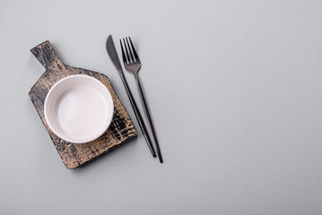 An empty plate on a gray concrete background with copy space