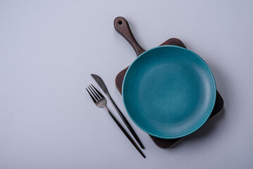 An empty plate on a gray concrete background with copy space