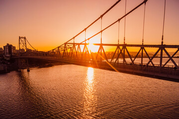 Fototapeta na wymiar Hercilio luz cable bridge with sunset in Florianopolis. Aerial view
