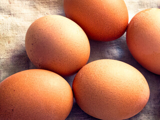 Brown eggs with textured surfaces grouped together, representing wholesome and organic eating.