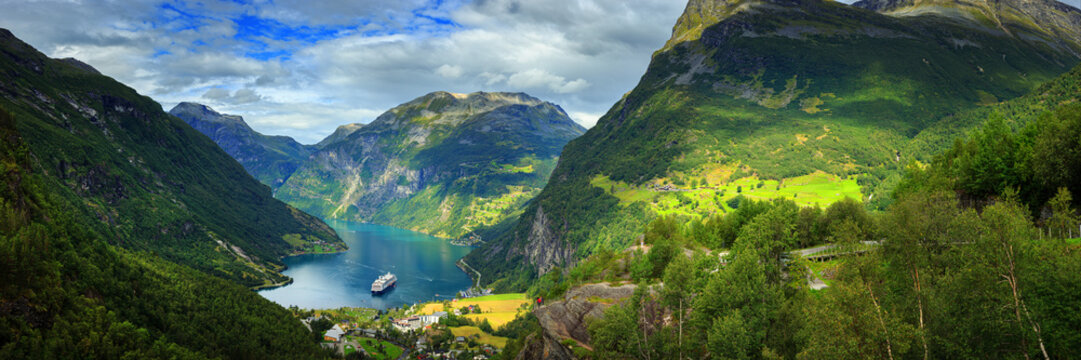 Panoramic view on cruise ships stand in the harbor of the Geiranger fjord, Norway	