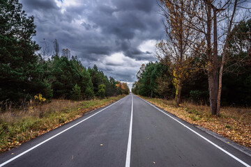 Perspective view of along the road, autumn, dramatic clouds on background