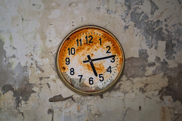 Old broken rusty wall clock in an abandoned building in Pripyat, Chornobyl Exclusion zone, Ukraine