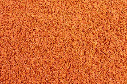 Background and texture of red paprika powder, top view. Dry ground red pepper, seasoning, background, top view. Ground red pepper.