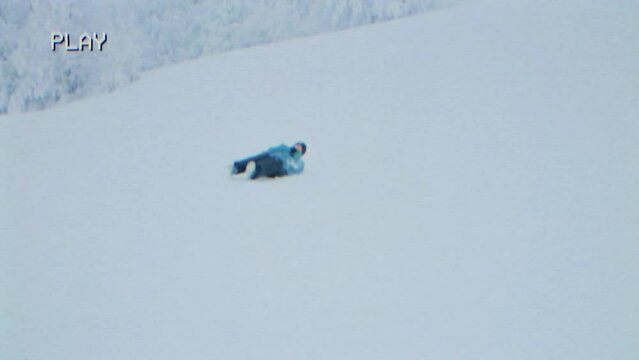 Fake VHS capture:iIn the midst of winter's frosty embrace, a gleeful kid rolls down a snowy hill with unbridled joy.
