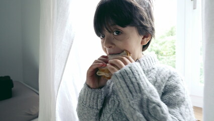 Happy Boy Enjoying Sandwich Close-Up, Small Child Eating Carb-Rich Snack in Afternoon, standing by...