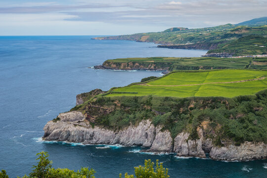 Aerial view from Tio Domingos viewpoint to cliff, fields and mountains next to the Atlantic Ocean, São Miguel - Azores PORTUGAL