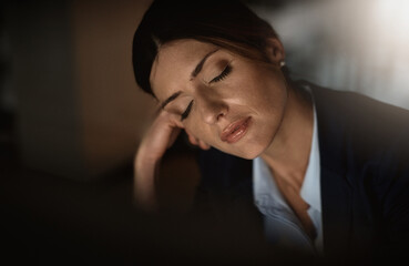 Sleeping, night or tired businesswoman by computer overwhelmed by deadlines with fatigue at desk....