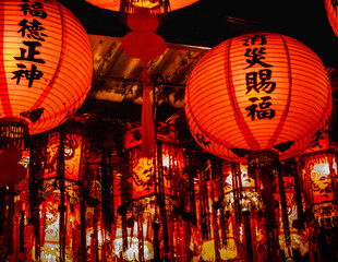 Array of pendant lanterns and palace lamps are installed on a local temple's ceiling in New Taipei...
