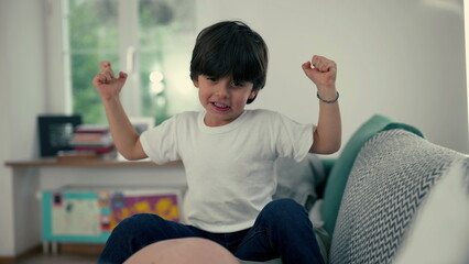 Proud Little Powerhouse - Adorable small Boy Flexing Arms at Home, Showcasing His Growing Strength...