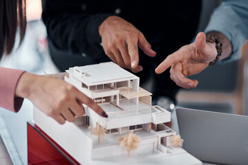 Hands, architect group and model of building with pointing for ideas, advice or planning for...