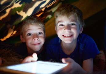 Portrait, happy kids and brothers on tablet in home tent for game, movie and streaming cartoon...