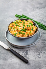 Egg spread with green onions and curry on grey background