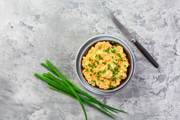 Egg spread with green onions and curry on grey background