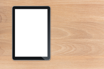 the tablet is on the wood table