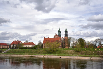 Naklejka na ściany i meble Historic buildings and towers of the cathedral on the river Warta in the city of Poznan