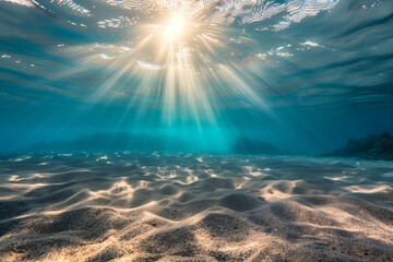 Fototapeta na wymiar Sunlight streams underwater over sandy seabed