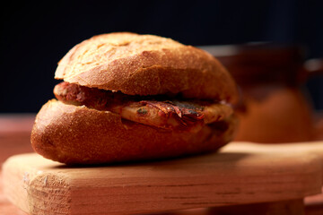 Tamale cake also known as guajolota, it is a tamale placed inside a cake and is a typical preparation of Mexico, placed on a piece of wood in the background a cup of the region